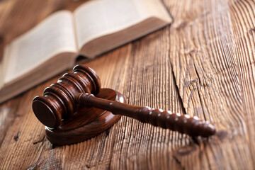 Law theme. Lawyers office. Gavel on the rustic brown desk. 