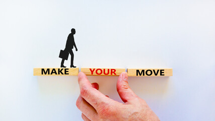Make your move symbol. Wooden blocks with words 'Make your move'. Beautiful white background, businessman hand, businessman icon. Business, make your move concept, copy space.