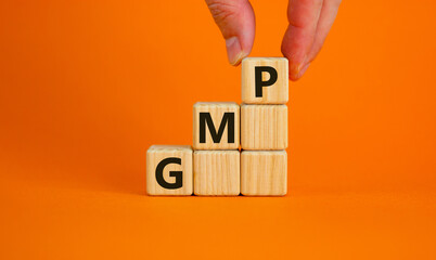 GMP, good manufacturing practice symbol. Concept words GMP, good manufacturing practice on cubes on a beautiful orange background. Business and GMP, good manufacturing practice concept. Copy space.
