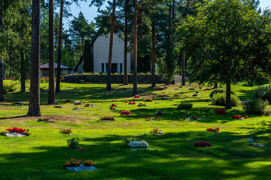 Cemetery with many graves decorated with colorful flowers