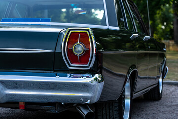 Close up of the tail light of a classic car from the sixties