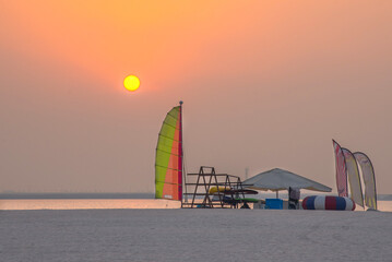 Beautiful sunset over the sea, view of windsurfing