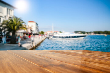 Sunset on the seashore and wooden table in the evening 