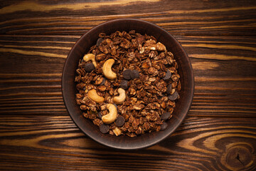 Obraz na płótnie Canvas Chocolate granola cereal with nuts in a bowl.