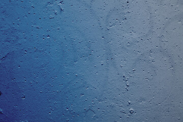 beautiful abstract grungy blue stucco wall background in cold mood with space for text.