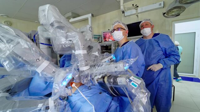 Surgeons during removal surgery. Medical robot da Vinci surgery technology machine