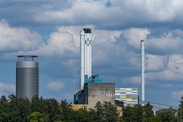 Fototapeta na wymiar Power plant with smokestacks against a cloudy sky