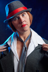 Portrait of ugle middle-aged woman with hat. Model posing in funny male style in the Studio.