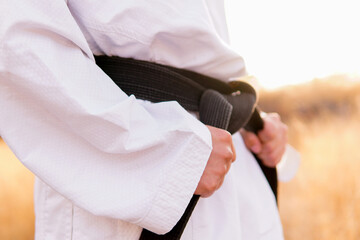Fototapeta premium Taekwondo black belt at sunrise