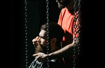 Man with long beard visiting barbershop. Vintage barber shop, shaving. Portrait bearded man....