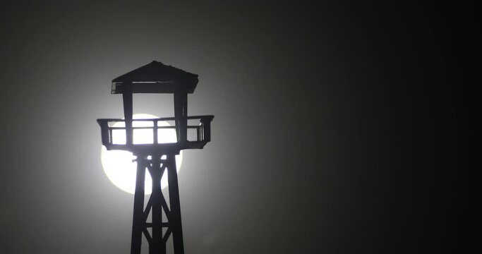 Creative artwork decoration. War concept. Silhouette of army watchtower at night. Selective focus