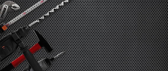 construction tools on horizontal grey trellised background