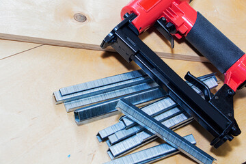 concept of furniture production and repair. Stapler and staples, working tool