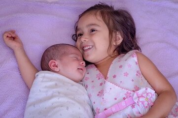 cute big sister with new newborn baby