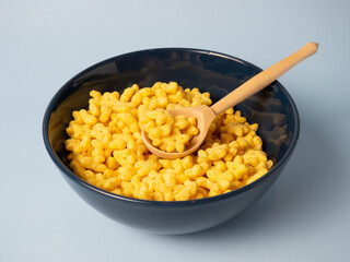 cornflakes stars, sweet cereal stars in a blue bowl on a blue background