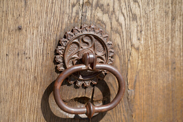 Door lock and door knocker on old doors photographed in daylight