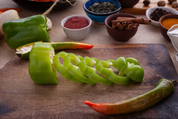 Sliced green pepper, prepared for cooking healthy vegetarian food with vegetables and spices. Healthy meal for people on a diet.