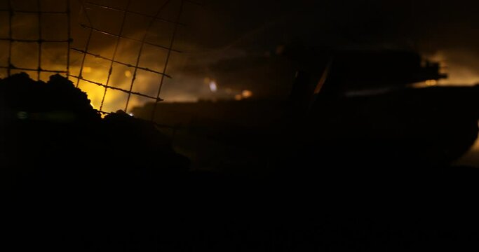 War Concept. Armored vehicle silhouette fighting scene on war foggy sky background at night. American tank moving in destroyed city. Slider shot