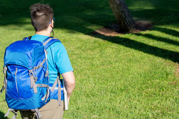 Naklejka premium young man walking in the forest. digital nomad concept.