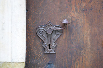 Door lock and door knocker on old doors photographed in daylight