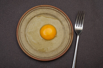 Closeup view of egg with fork table top breakfast concept