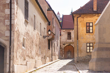 Fototapeta na wymiar Bratislava in the spring of 2020. Street in the historical center of the city. Old houses with tiled roofs.