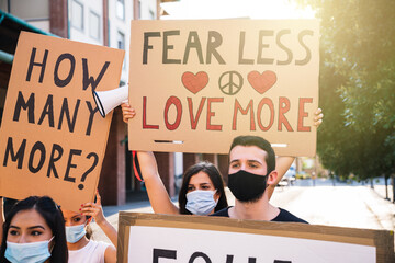 Group of young multiethnic demonstrators in a road - People protesting for equality and for stop...