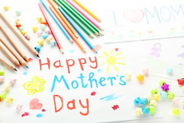 Text Happy Mother's Day with colorful pencils and paper stars on wooden background