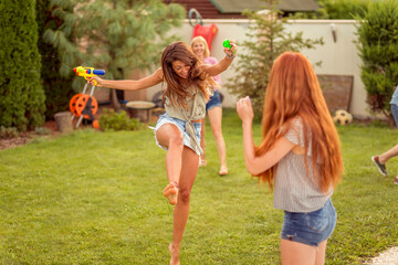 Fototapeta premium Friends having a squirt guns war