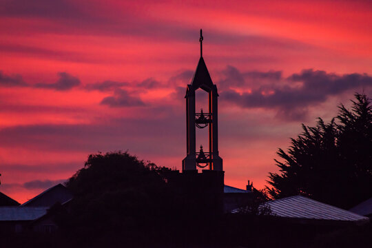 Sunrise time pink sky view to church with bells in Ancud, Chile