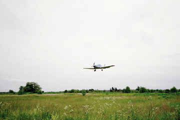 Fototapeta na wymiar Private aircraft. Light aircraft flying over the field