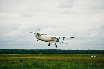 Fototapeta na wymiar Private aircraft. Light aircraft flying over the field