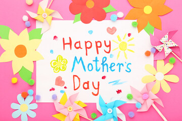 Text Happy Mother's Day with paper windmills and flowers on pink background