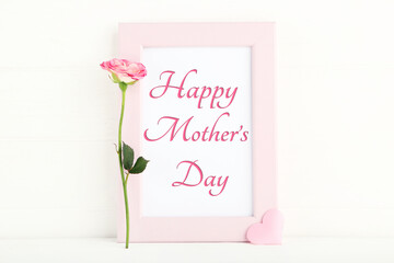 Text Mother's Day with rose flower and pink heart on white background