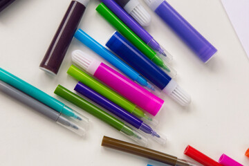 Fototapeta premium colorful markers lie on a white table