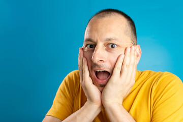 Excited male model exclaims in happiness, doesn`t expect to receive pleasant surprise, can`t...