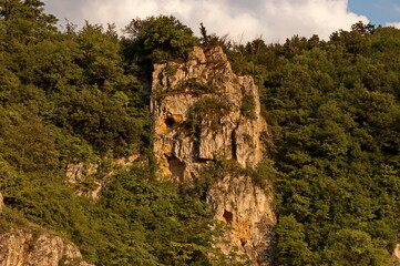 Panorama from the area of ​​Rusenski Lom Nature Park with high vertical limestone cliffs, overgrown with deciduous trees, Nisovo, Bulgaria 