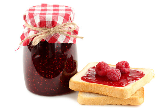 Toasts with raspberry jam and glass of jar isolated on white background