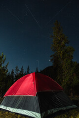 Outdoor Camping in a Red Tent Under Shooting stars in the woods