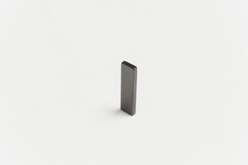 ferrite rectangular magnet with north and south pole isolated on white background.