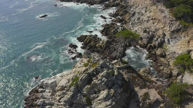 Slow Aerial Tilt Down Zoom in of the Rocky Shores of Big Sur Coast in California