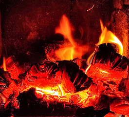 Wood fire oven with flame and burning wood.fire in a brick oven.Close up shot of burning firewood in the fireplace.