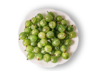 Fresh green gooseberries in a plate close-up, isolated. The view from top