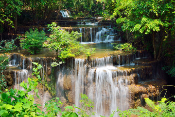 Close up of waterfall is surrounded by forests in Thailand.