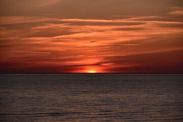Fototapeta premium sunset at sea with a calm water surface