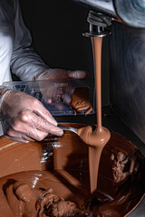 Preparing the hot chocolate syrup to make the chocolates in the mold