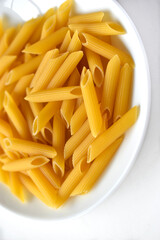 Yellow delicious pasta close-up on a white plate