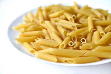 Yellow delicious pasta close-up on a white plate