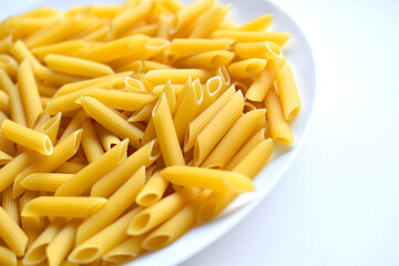 Yellow delicious pasta close-up on a white plate