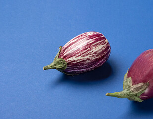 striped eggplant on a blue background. Healthy food concept.